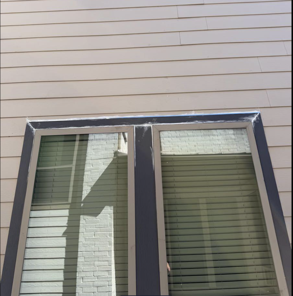 New siding and window trim installation — before