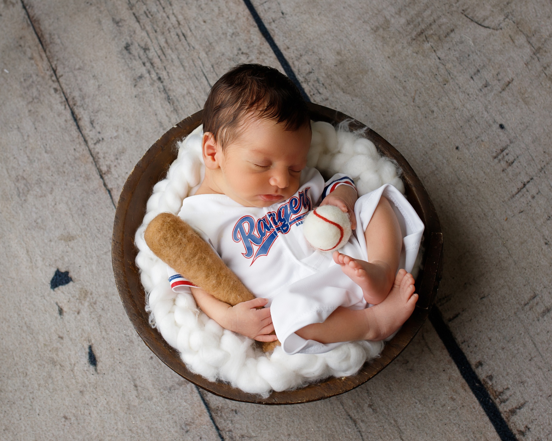 Angel's newborn son dressed in a Texas Rangers outfit