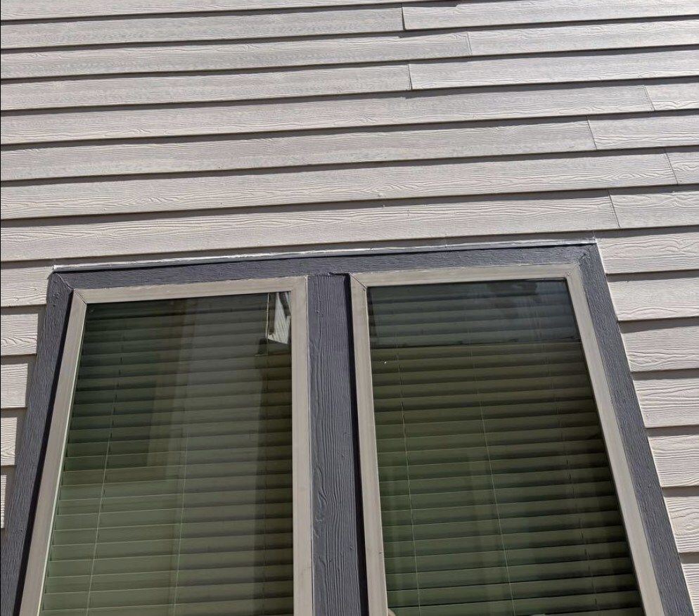 New siding and window trim installation — after